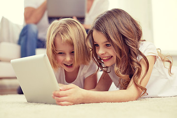 Image showing happy little girls with tablet pc computer at home