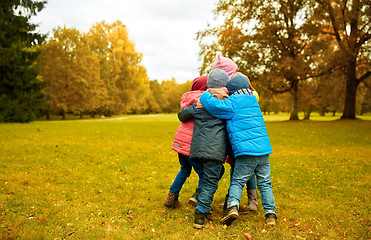 Image showing group of happy children hugging in autumn park