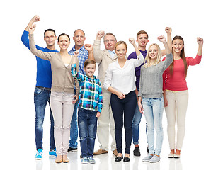 Image showing group of happy people showing fists