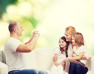 Image showing happy family with camera at home