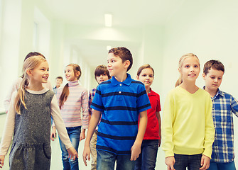 Image showing group of smiling school kids walking in corridor