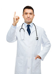 Image showing male doctor in white coat pointing finger up