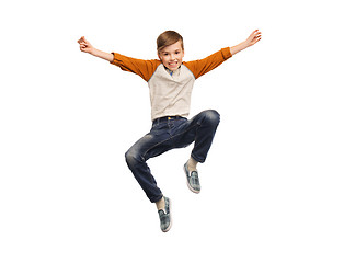 Image showing happy smiling boy jumping in air