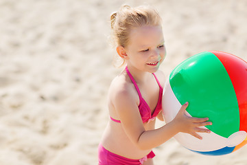 Image showing happy little girl playing inflatable ball on beach