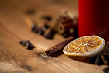 Image showing cinnamon, anise and dried orange on wooden board