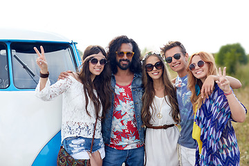 Image showing smiling young hippie friends over minivan car