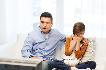 Image showing father and son watching horror movie on tv at home