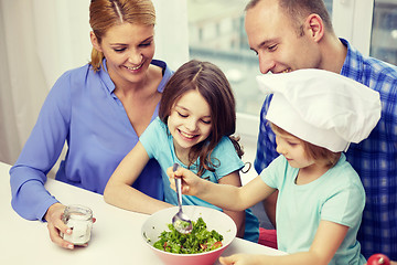 Image showing happy family with two kids cooking at home