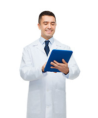 Image showing smiling male doctor in white coat with tablet pc