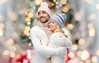 Image showing smiling couple in winter clothes hugging