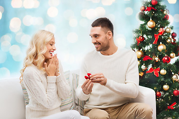 Image showing man giving woman engagement ring for christmas