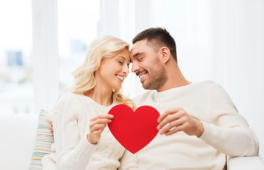 Image showing happy couple with red heart hugging at home