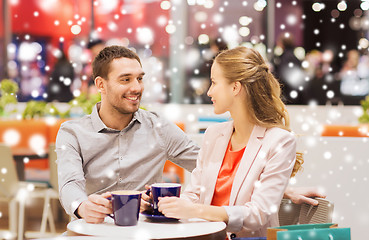 Image showing happy couple with shopping bags drinking coffee