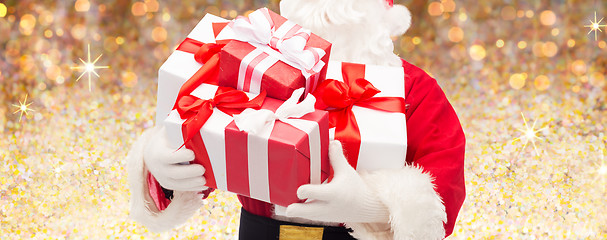 Image showing man in costume of santa claus with gift boxes