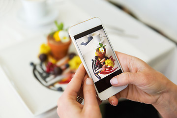 Image showing close up of woman picturing food by smartphone