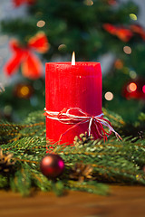 Image showing fir branch wreath with candle on wooden table