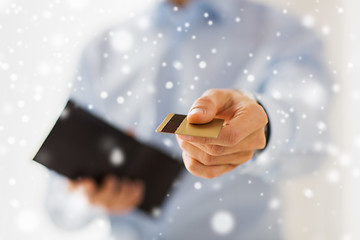 Image showing close up of man holding wallet and credit card