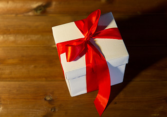 Image showing close up of christmas  gift box on wooden floor