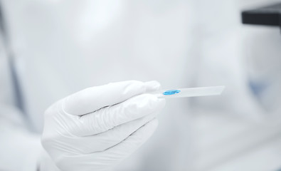 Image showing close up of scientist hand with test sample in lab