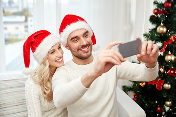 Image showing couple taking selfie with smartphone at christmas