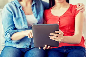 Image showing close up of lesbian couple with tablet pc at home