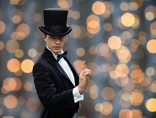 Image showing magician in top hat pointing finger up