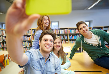 Image showing students with smartphone taking selfie in library