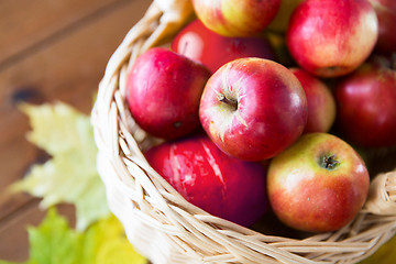 Image showing close up of basket with apples on wooden table