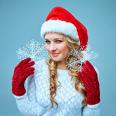 Image showing Beautiful young woman in Santa Claus clothes with snowflakes