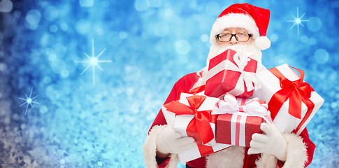 Image showing man in costume of santa claus with gift boxes