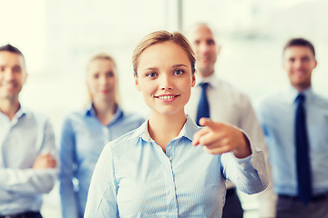 Image showing smiling businesswoman pointing finger on you