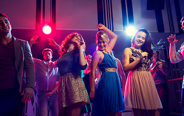 Image showing smiling friends dancing in club