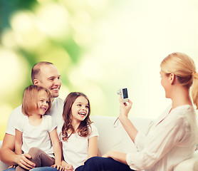 Image showing happy family with camera at home