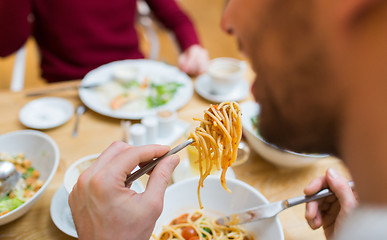 Image showing close up man eating pasta for dinner at restaurant