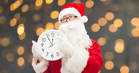 Image showing man in costume of santa claus with clock