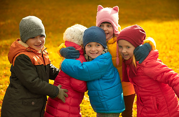 Image showing group of happy children hugging in autumn park