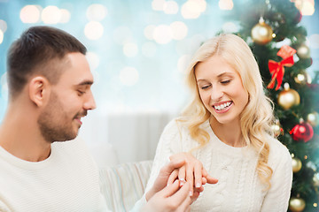 Image showing man giving woman engagement ring for christmas