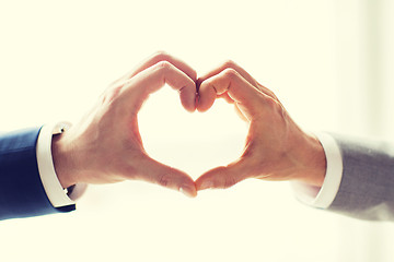 Image showing close up of male gay couple hands showing heart