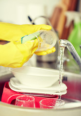 Image showing close up of woman hands washing dishes in kitchen