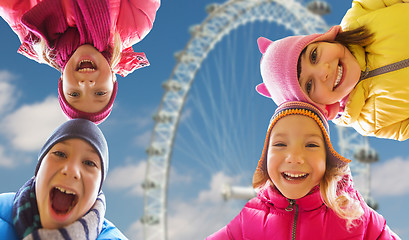 Image showing happy little children faces over ferry wheel