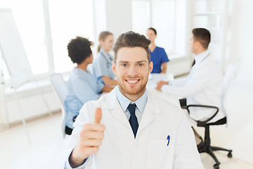 Image showing happy doctor over group of medics at hospital