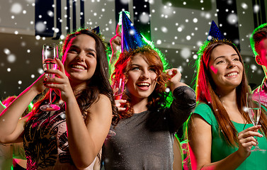 Image showing smiling friends with glasses of champagne in club