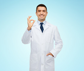 Image showing smiling doctor in white coat showing ok hand sign