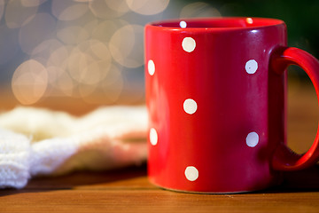 Image showing red polka dot tea cup on wooden table