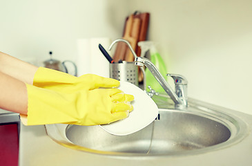 Image showing close up of woman hands washing dishes in kitchen