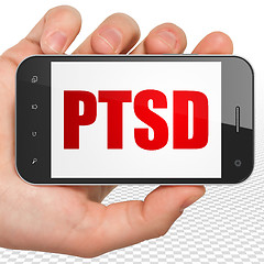 Image showing Healthcare concept: Hand Holding Smartphone with PTSD on display