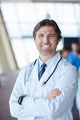 Image showing group of medical staff at hospital, handsome doctor in front of 