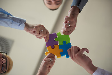 Image showing business people group assembling jigsaw puzzle