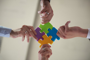 Image showing business people group assembling jigsaw puzzle