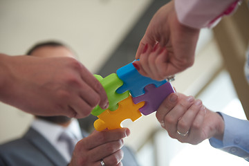 Image showing business people group assembling jigsaw puzzle